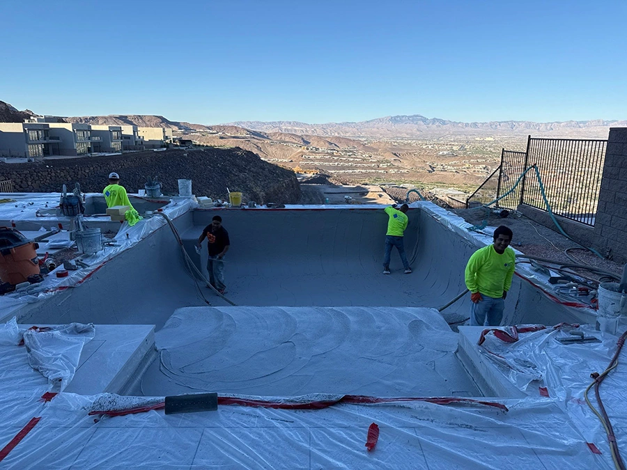 Workers on pool plastering stage